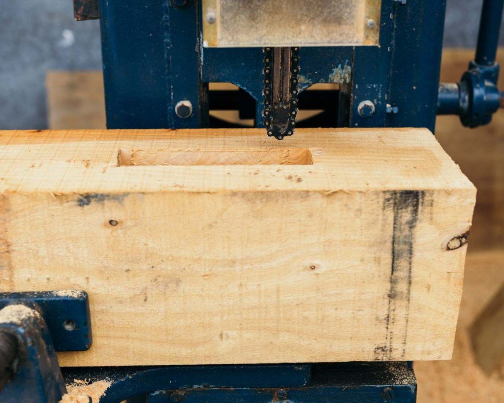 a tool cutting into a wooden 2x4