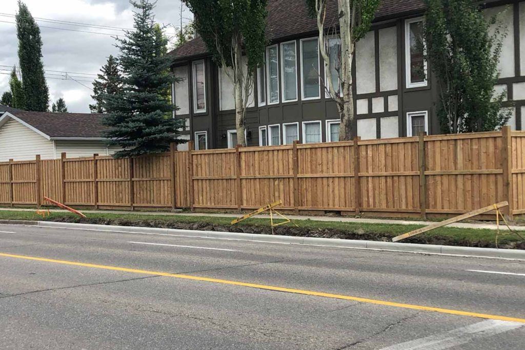 a street with a wooden fence